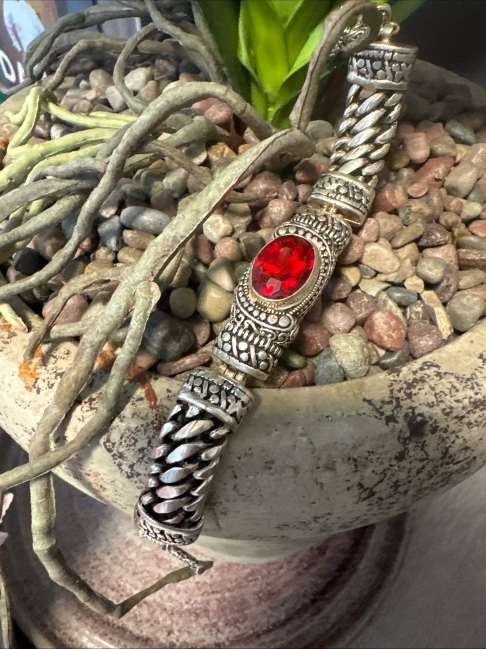 New Batu bracelet a prominent red stone in intricately carved sterling silver.